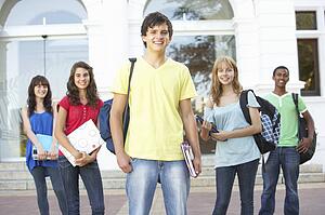 Group Of Teenage Students Standing Outside College Building