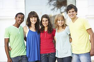 Group Of Teenage Students Standing Outside College Building