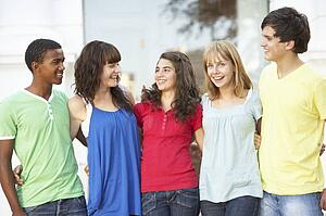 Group Of Teenage Students Standing Outside College Building