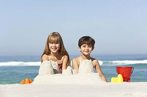Children Building Sandcastles On Beach Holiday