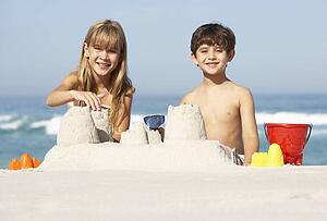 Children Building Sandcastles On Beach Holiday