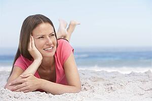 Young Woman Relaxing On Sandy Beach