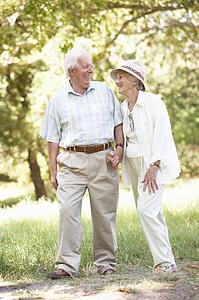 Senior Couple Walking In Park
