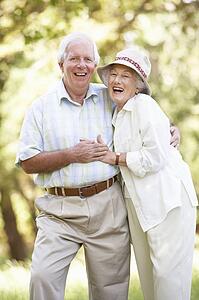 Senior Couple Walking In Park