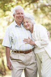 Senior Couple Walking In Park
