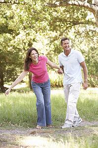 Portrait Of Young Couple Walking In Park