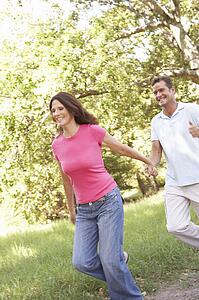 Portrait Of Young Couple Walking In Park