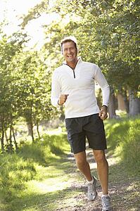 Middle Aged Man Jogging In Park