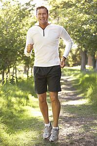 Middle Aged Man Jogging In Park