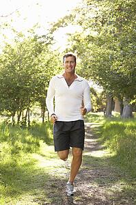 Middle Aged Man Jogging In Park