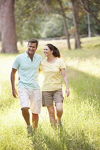 Portrait Of Young Couple Walking In Park