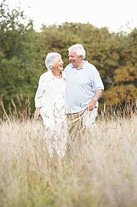 Senior Couple Walking In Park