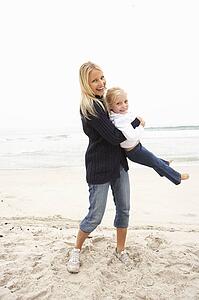 Mother And Daughter On Holiday Having Fun On Winter Beach
