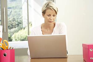 Woman Using Laptop At Home