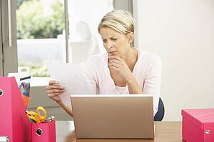 Woman Using Laptop At Home