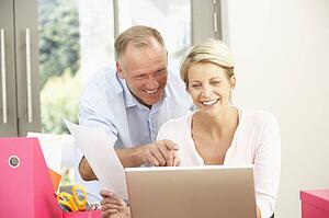 Couple Using Laptop At Home