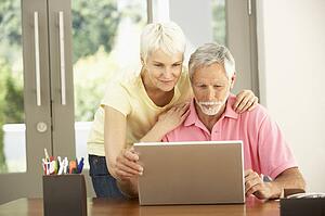 Senior Couple Using Laptop At Home