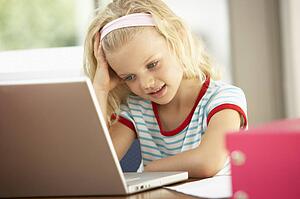 Young Girl Using Laptop At Home
