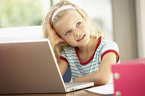 Young Girl Using Laptop At Home