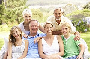 Extended Family Relaxing In Garden