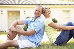 Couple Sitting Outside Dream Home