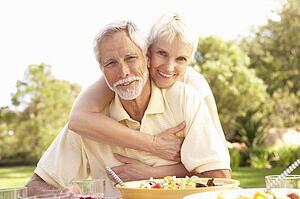 Senior Couple Enjoying Meal In Garden
