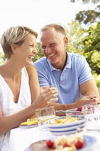 Couple Enjoying Meal In Garden