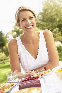 Woman Enjoying Meal In Garden