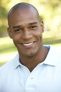 Portrait Of Young Man Sitting In Park