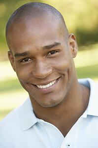 Portrait Of Young Man Sitting In Park
