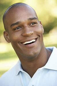Portrait Of Young Man Sitting In Park