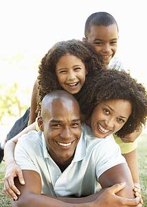 Portrait of Happy Family Piled Up In Park