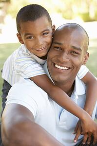 Portrait of Happy Father and Son In Park