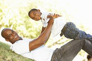 Portrait of Happy Father and Son In Park