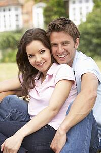 Affectionate Couple Relaxing At Home In Garden Together
