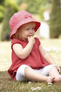 Young Girl Playing In Garden At Home
