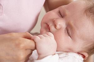 Close Up Of Baby Boy Holding Mothers Hand