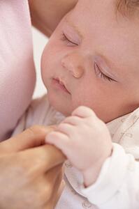 Close Up Of Sleeping Baby Boy Holding Mothers Hand