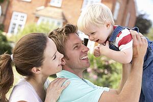 Family Playing Together In Garden At Home