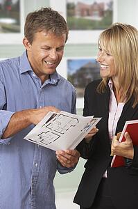 Female Estate Discussing Property Details With Client