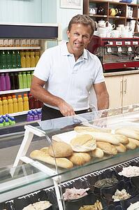 Man Working Behind Counter In Café
