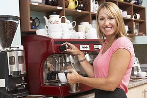 Woman Making Coffee In Café