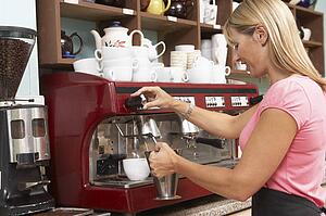 Woman Making Coffee In Café