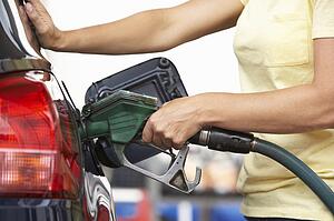 Detail Of Female Motorist Filling Car With Petrol At Petrol Station