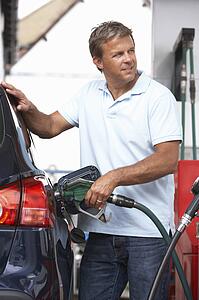Detail Of Male Motorist Filling Car With Diesel At Petrol Station