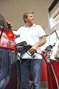 Detail Of Female Motorist Filling Car With Petrol At Petrol Station