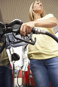 Female Motorist Filling Car With Diesel At Petrol Station