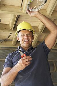 Electrician Working On Wiring In New Home