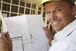 Architect With Plans In New Home