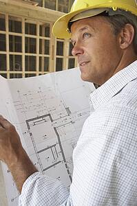 Architect With Plans In New Home
